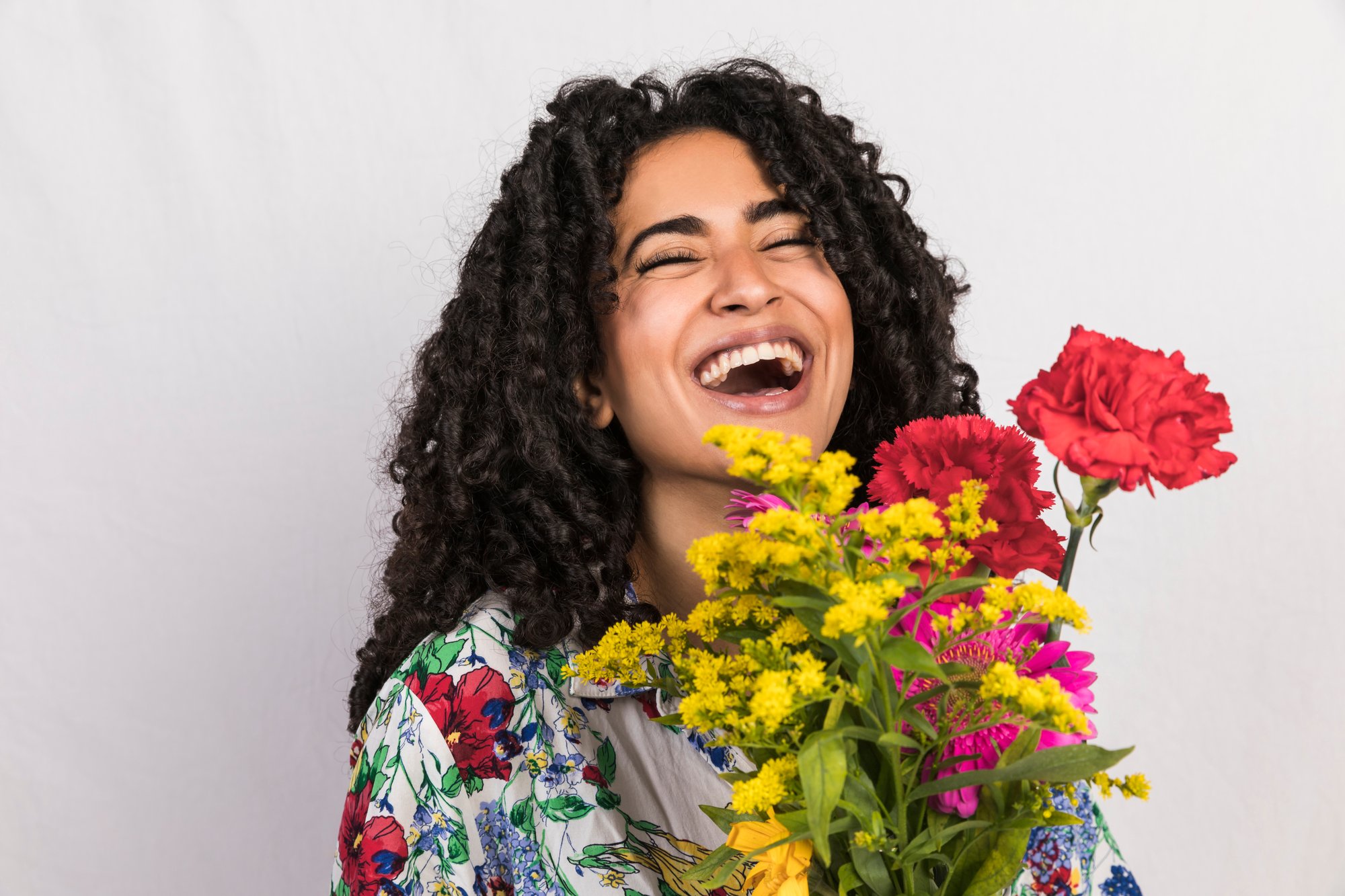 bright-woman-laughing-with-bunch-flowers